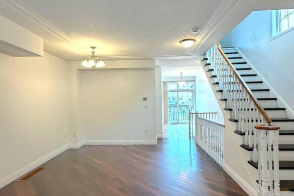 Interior view showing a living room, staircase, and doorway leading to a balcony. - 19 - 10 Post Oak Drive, Richmond Hill