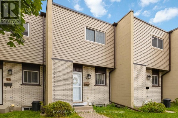 Close-up of a townhouse entrance with a white door and beige siding. - 19 - 178 Grulke Street, Kitchener