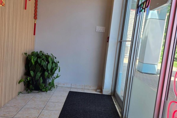 Interior entrance area with tiled floor, potted plant, and light switch. - 19 - 4400 Sheppard Avenue E, Toronto