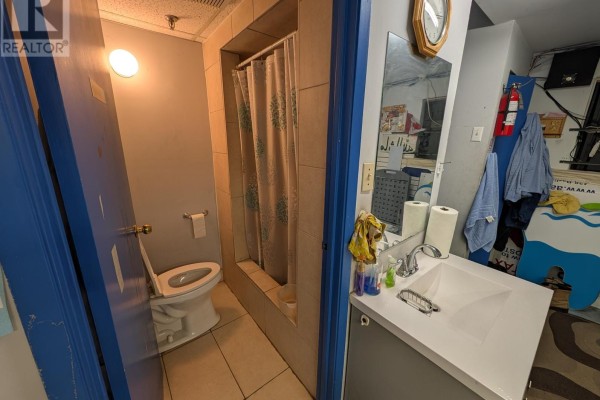 Bathroom with shower, toilet, and sink, featuring blue accents and tiled walls - 19 - 50 Weybright Court, Toronto