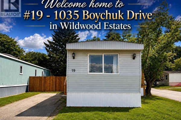 Front view of a manufactured home with light gray siding and dark trim. - 19 1035 Boychuk Drive, Saskatoon
