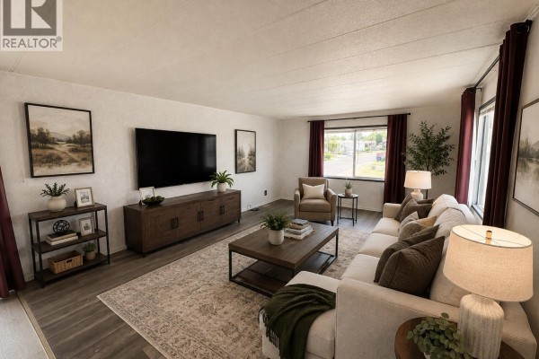 Living room with a sectional sofa, coffee table, entertainment unit, and large TV. - 19 1035 Boychuk Drive, Saskatoon