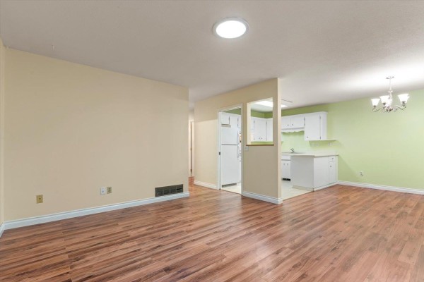 White kitchen with white appliances, cabinets, and light green walls. - 19 3350 Elmwood Drive, Abbotsford