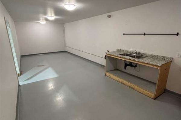 Room with gray flooring, granite countertop, and sink - 19 733 North Link Road, Ile Des Chenes