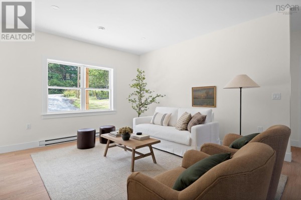 Living room with white sofa, tan chairs, wooden coffee table, and large window. - 19 Ardoise Lane, Ardoise