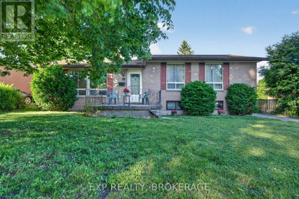 Exterior view of the house showing the driveway and front yard with grass and leaves. - 19 Convay Crescent, Brockville