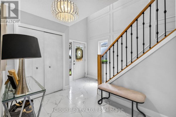 Interior foyer with a bench, console table, and double doors leading outside. - 19 Crusoe Place, Ingersoll