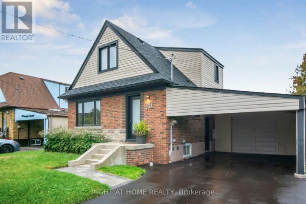 Side view of a two-story brick house with a carport and garage door. - 19 Flempton Crescent, Toronto