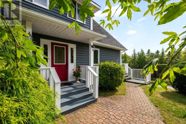 Close-up of the entrance with a red door, steps, and pathway lined with greenery. - 19 Graves Island Road, East Chester