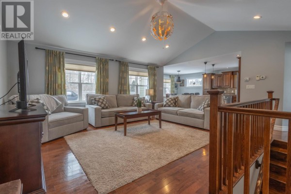 Open concept kitchen and dining area with dark wood cabinets, granite countertops, and a large island. - 19 Kehough Court, Cornwall