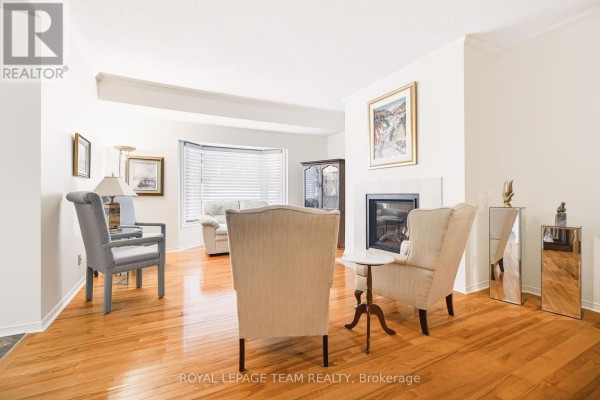 View of the living area from across the room showing furniture and a bay window. - 19 Pine Needles Court, Ottawa