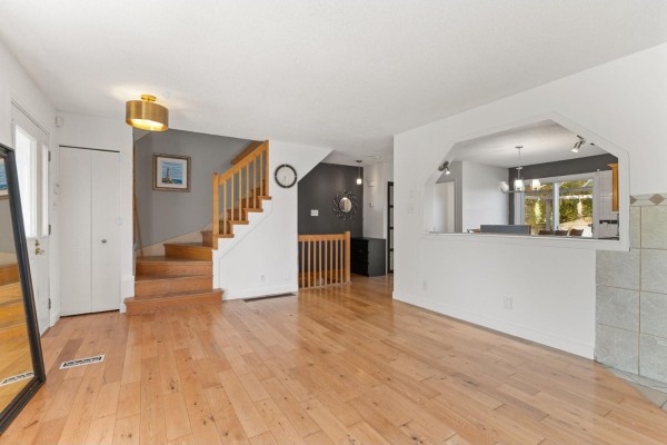 Living room looking towards the kitchen pass-through, featuring wood floors. - 19 Rue Des Graves, Gatineau