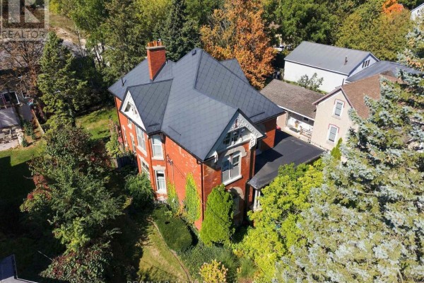 Aerial view of the brick house's roof and surrounding trees. - 19 Sparling Street, Huron East