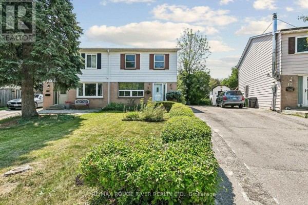 Side view of townhouse complex at 19 Tinbury Place, Toronto, with driveway. - 19 Tinbury Place, Toronto
