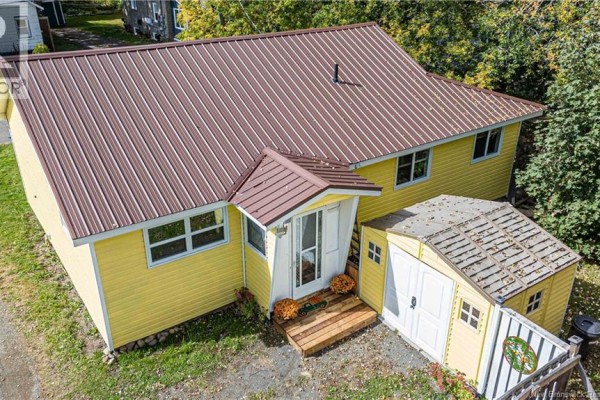 Rear view of a yellow house with a brown metal roof and an attached yellow shed. - 19 Victory Avenue, Fredericton