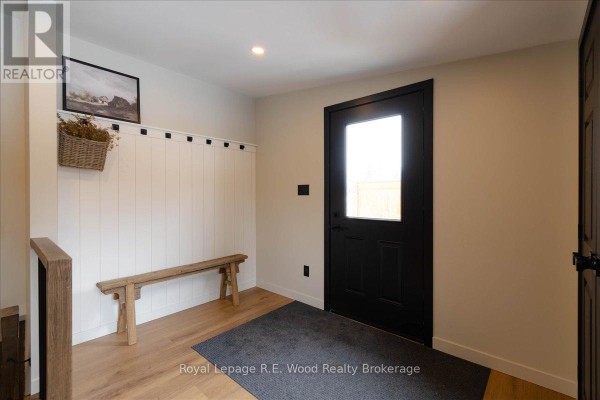 Spacious garage interior with loft area, storage, and organized tools on display. - 19 Washington Street, Norwich