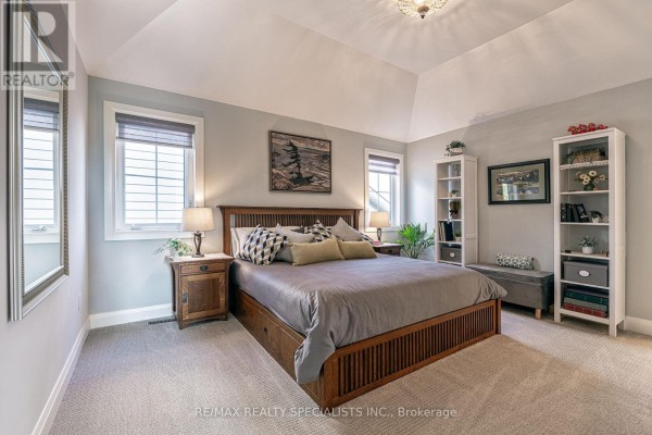 King-size bed, vaulted ceiling, and shelving in bedroom - 190 Courtland Street Blue Mountains