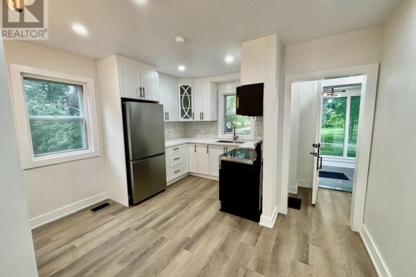 Interior view of a small entryway with two doors and dark gray tiled flooring. - 1900 Bruce Road 15, Kincardine