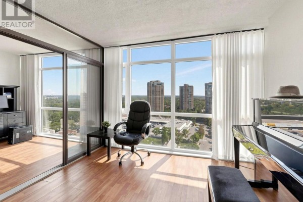 Compact kitchen with dark wood cabinets, granite countertops, and tiled floor. - 1901 - 1555 Finch Avenue E, Toronto