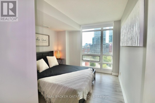 Hallway with light wood floors, light grey walls, and a Gucci snake artwork. - 1902 - 381 Front Street, Toronto