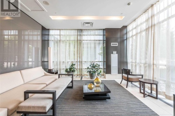 Lounge area with contemporary furniture, large windows, and plants - 1904 - 30 Herons Hill Way, Toronto