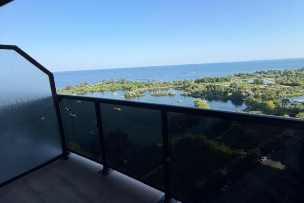 Balcony view overlooking water, trees, and boats on a sunny day. - 1905 - 80 Marine Parade Drive, Toronto