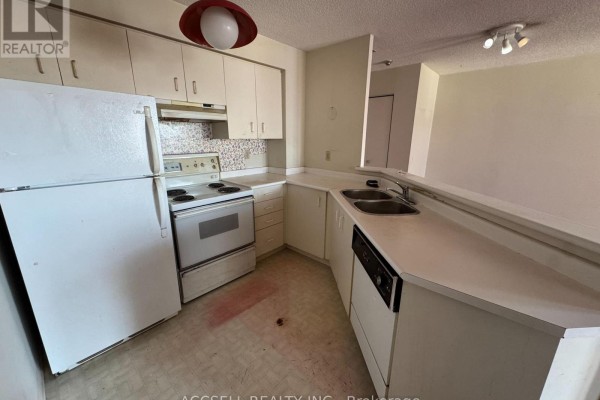 Kitchen with white cabinets, white appliances, and a double sink. - 1906 - 25 Grenville Street, Toronto