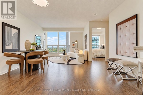 Open concept living area with dining table and living room furniture visible. - 1908 - 23 Lorraine Drive, Toronto