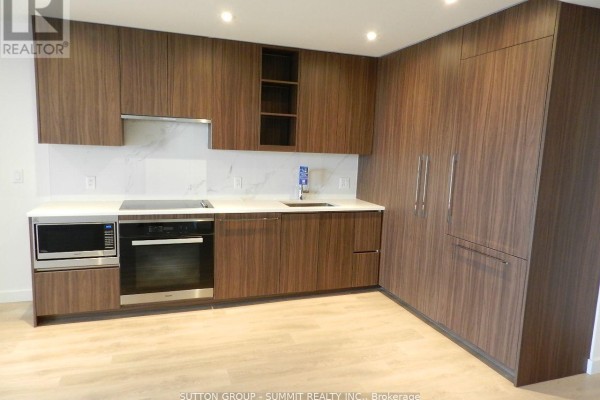 Close-up of the kitchen layout with built-in appliances and ample storage. - 1908 - 25 Mcmahon Avenue, Toronto