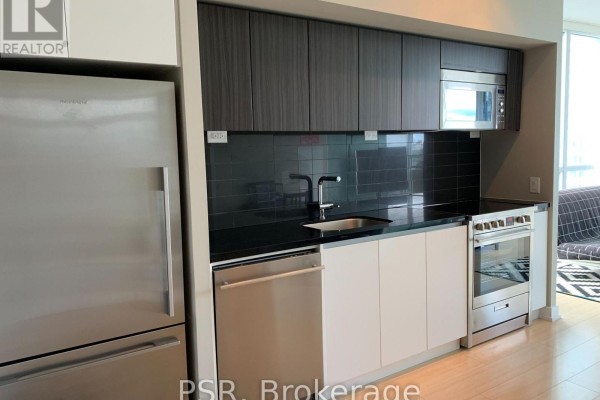 Kitchenette with stainless steel appliances, black backsplash, and modern cabinetry. - 1908 - 75 Queens Wharf Road, Toronto