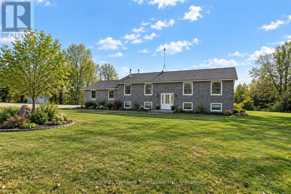 Spacious kitchen with oak cabinets, green countertops, and a view of the backyard. - 191 Emerson Road, Centre Hastings