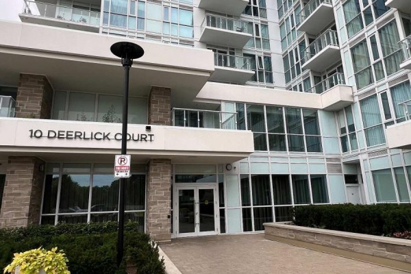 The main entrance of a modern condo building with the address '10 Deerlick Court'. - 1910 - 10 Deerlick Court, Toronto