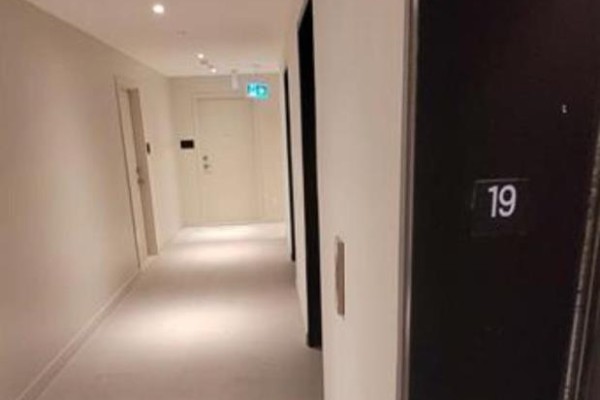 A clean, well-lit hallway with doors and apartment number '19' visible. - 1910 - 10 Deerlick Court, Toronto