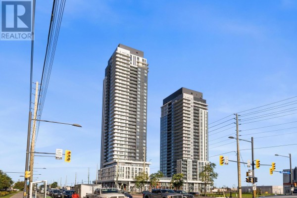 Exterior view of two tall apartment buildings with glass balconies and dark facades against a bright sky. - 1910 - 21 Meadowdale Road, Vaughan