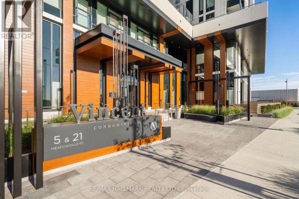 Entrance to the Vincent Condominium building at 5 & 21 Meadowdale Rd, featuring wood accents and modern signage. - 1910 - 21 Meadowdale Road, Vaughan