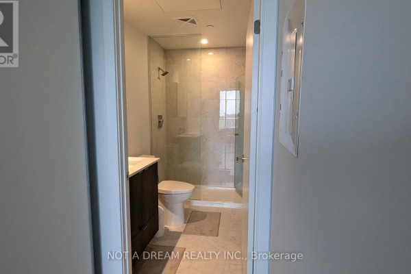 Modern kitchen with white cabinets, stainless steel appliances, and quartz countertops. - 1911 - 1928 Lakeshore Boulevard W, Toronto