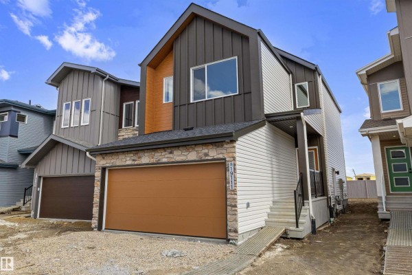 Bright entryway with double doors, window, and light-colored walls - 19111 20 Av Nw, Edmonton