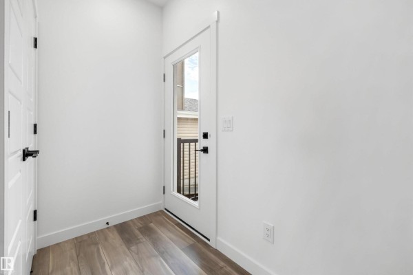 Entry area featuring two doors, one with a window, and a small rug - 19111 20 Av Nw, Edmonton