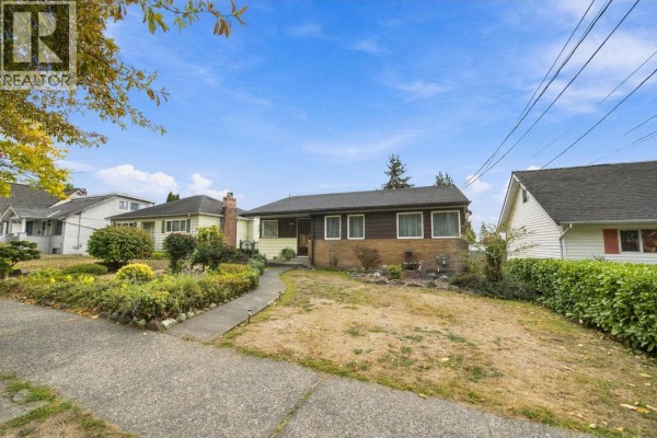 The front of a house on a clear day, showing the entryway and lawn. - 1912 London Street, New Westminster
