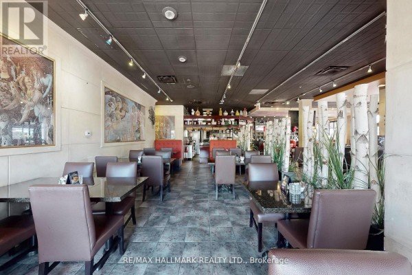 Interior view with tables, artwork on walls, and open layout - 192 Mcewan Drive E, Caledon
