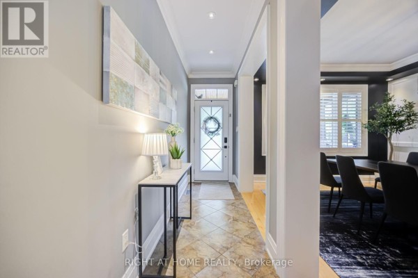 Interior entryway with a console table, lamp, and a glass-paneled front door. - 192 Robirwin Street, Whitchurch Stouffville