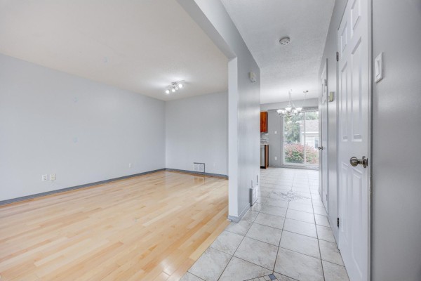 View from the entryway to an open-concept living and dining area with light wood floors. - 192 Rue De Châteaufort, Gatineau