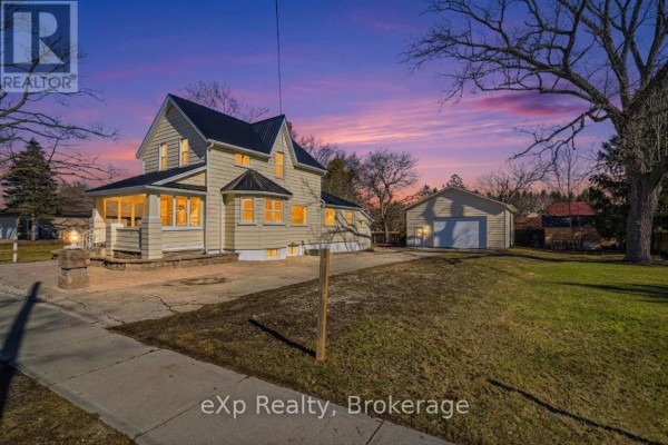House with garage and porch at twilight - 192 William Street W North Middlesex