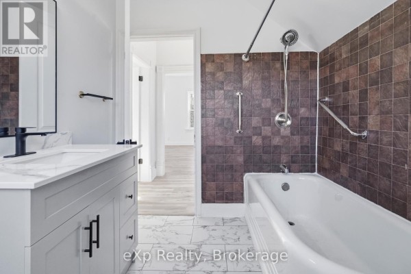 Bathroom vanity, marble tile floor, tub with grab bars - 192 William Street W North Middlesex
