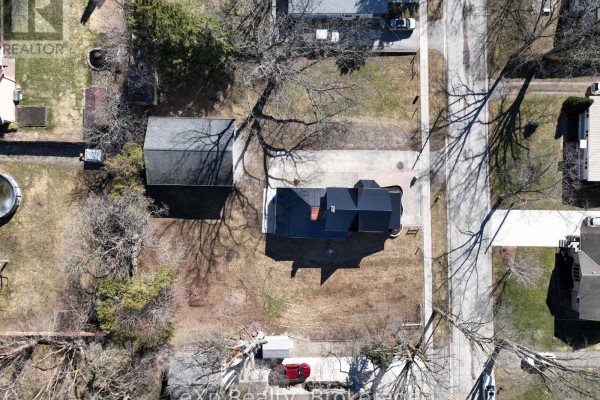 House with black roof and detached garage - 192 William Street W North Middlesex