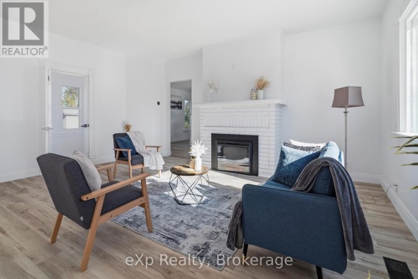 Living room with fireplace, seating, and coffee table - 192 William Street W North Middlesex