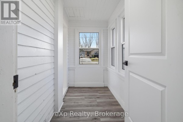 Renovated entryway with shiplap walls and hardwood floors - 192 William Street W North Middlesex
