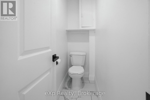 Toilet and medicine cabinet in a modern bathroom - 192 William Street W North Middlesex
