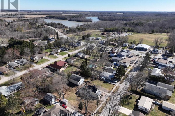 Aerial view of neighborhood with houses and water in distance - 192 William Street W North Middlesex