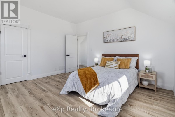 Bedroom with bed, nightstand, wall art - 192 William Street W North Middlesex